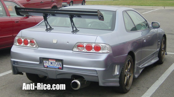 A silver coupe sporting a six-foot bolt-on rear wing